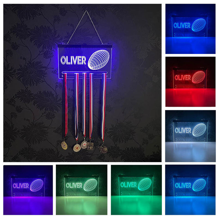 Personalised Goal Glow Medal Hanger featuring a custom name and rugby graphic, illuminated with colorful LED lights, displayed against a dark background