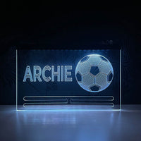 Football-themed medal hanger with USB-powered LED illumination, featuring custom engraving and displaying several hard-earned football medals beneath