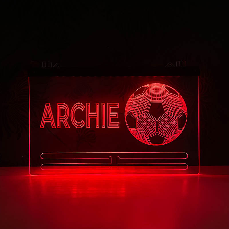 Stylish football medal rack with a personalized name, lit with changing LED colors, designed to hold multiple football medals, set in a modern bedroom